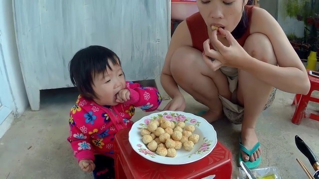 'Mom of Sam - Mom and baby frying food'