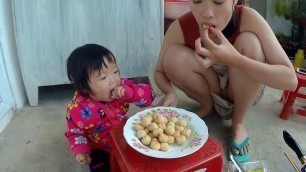 'Mom of Sam - Mom and baby frying food'