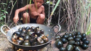 'Smart boy frying snail in wild for food'