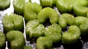 'Chopped celery sauteeing on a black frying pan, healthy vegan food concept. Stock footage. Close up'