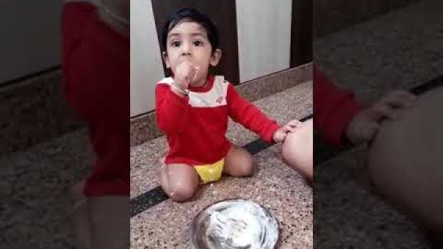 '11 month old baby eating his food'