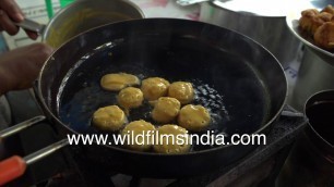 'Street Food in Delhi - Deep frying mini pancakes laced with spices'